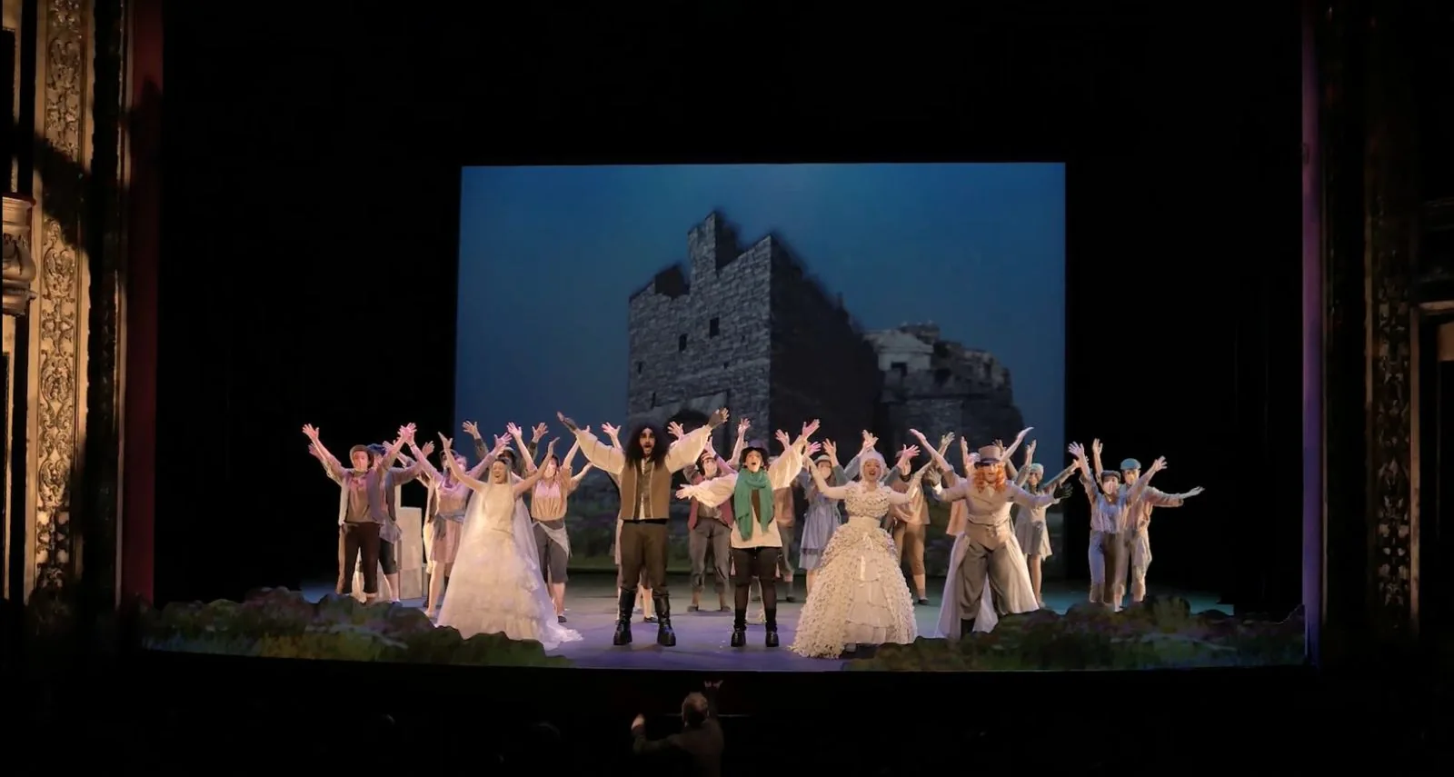 Tres personajes de El Gigante Egoísta cantan en el jardín